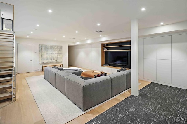 living area with wood finished floors and recessed lighting