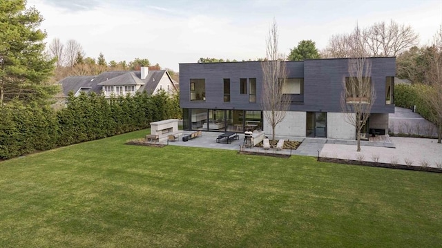 rear view of property with a patio area and a lawn