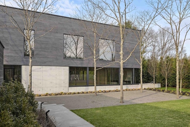 back of property with a lawn