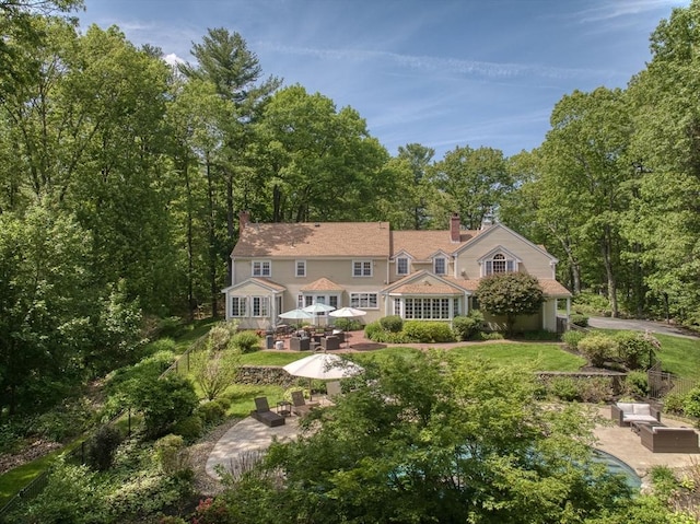 171 Brentwood Cir, North Andover, MA 01845 - back of property with a patio, a chimney, and an outdoor living space