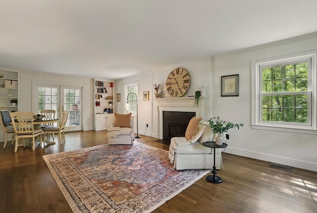 171 Brentwood Cir, North Andover, MA 01845 - living room with a fireplace with flush hearth, dark wood-style flooring, ornamental molding, built in features, and baseboards