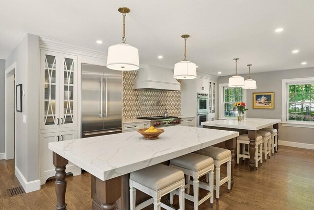 171 Brentwood Cir, North Andover, MA 01845 - kitchen with a center island, appliances with stainless steel finishes, dark wood-style floors, baseboards, and tasteful backsplash