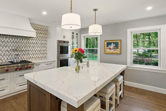 171 Brentwood Cir, North Andover, MA 01845 - kitchen with appliances with stainless steel finishes, backsplash, baseboards, white cabinetry, and dark wood-style floors