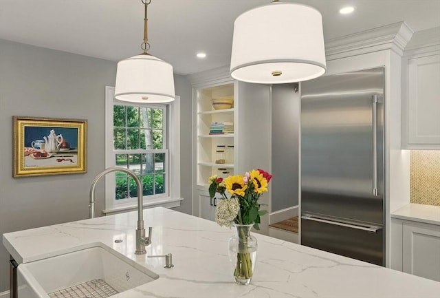 171 Brentwood Cir, North Andover, MA 01845 - kitchen featuring a sink, high end fridge, built in shelves, hanging light fixtures, and white cabinetry