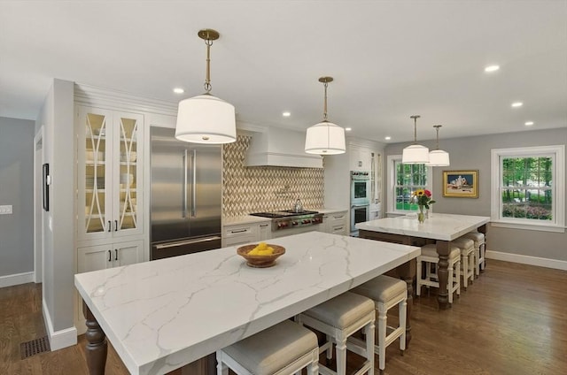 171 Brentwood Cir, North Andover, MA 01845 - kitchen featuring a kitchen island, appliances with stainless steel finishes, baseboards, decorative backsplash, and recessed lighting