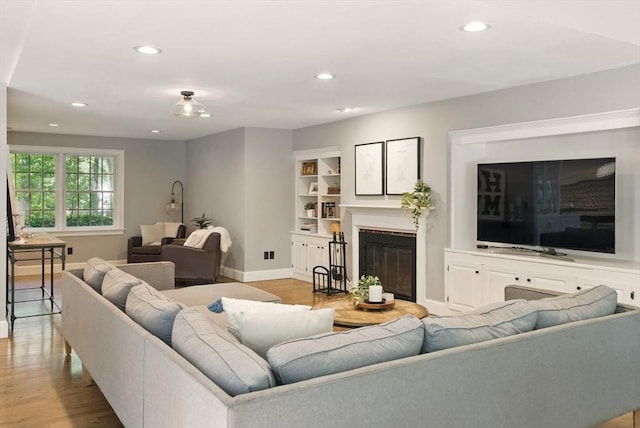 171 Brentwood Cir, North Andover, MA 01845 - living area with wood finished floors, baseboards, recessed lighting, and a glass covered fireplace