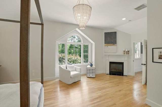 171 Brentwood Cir, North Andover, MA 01845 - living room with healthy amount of natural light, a chandelier, wood finished floors, a fireplace with flush hearth, and recessed lighting