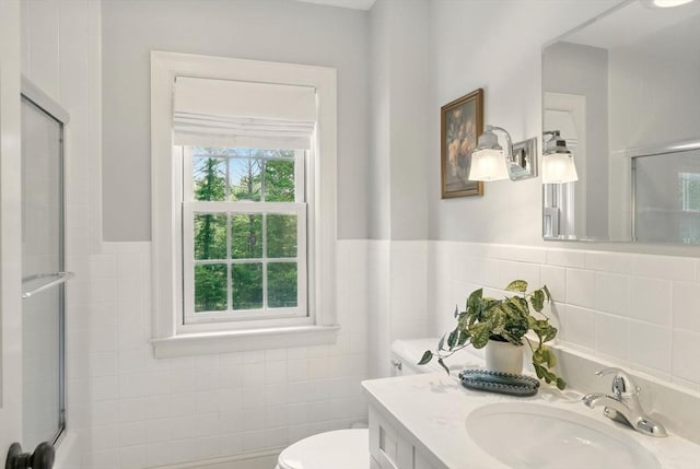 171 Brentwood Cir, North Andover, MA 01845 - bathroom featuring an enclosed shower, tile walls, toilet, vanity, and a wainscoted wall
