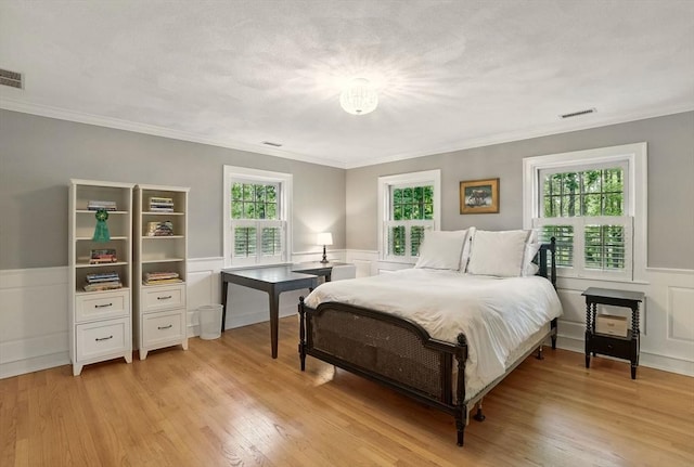171 Brentwood Cir, North Andover, MA 01845 - bedroom with wainscoting, ornamental molding, light wood finished floors, and a decorative wall