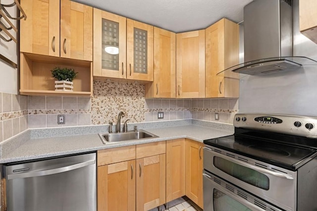 kitchen featuring sink, wall chimney exhaust hood, decorative backsplash, light brown cabinetry, and stainless steel appliances