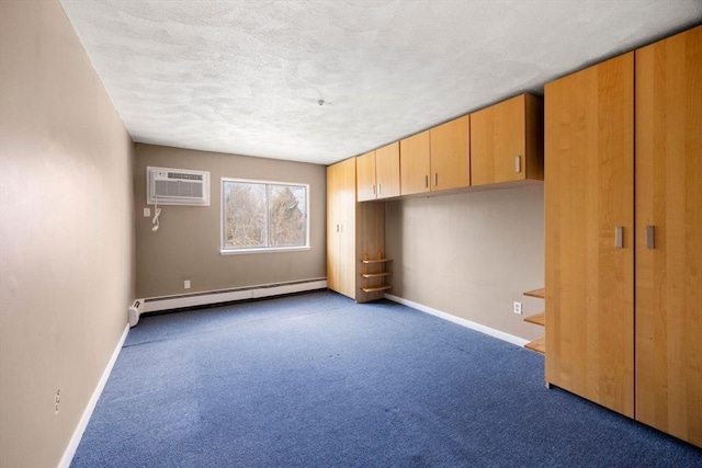 unfurnished bedroom featuring baseboard heating, a wall mounted AC, a textured ceiling, and dark colored carpet