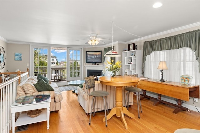 16 Ocean St Unit A, Salisbury, MA 01952 - living area with crown molding, a ceiling fan, light wood finished floors, and a fireplace