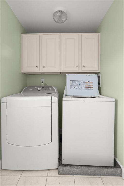 16 Ocean St Unit A, Salisbury, MA 01952 - washroom featuring cabinet space and separate washer and dryer
