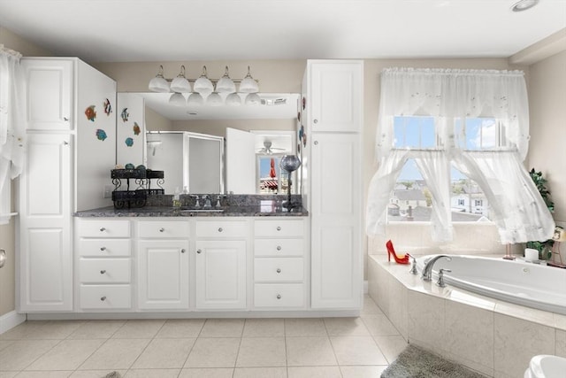 16 Ocean St Unit A, Salisbury, MA 01952 - full bathroom with vanity, a shower stall, a bath, and tile patterned floors