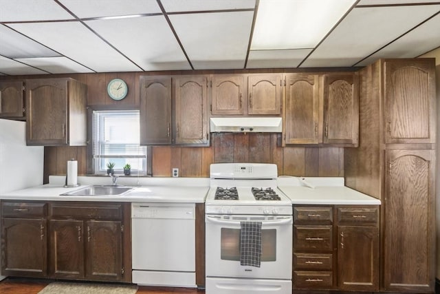 45 Franklin Ave, Quincy, MA 02170 - kitchen with white appliances, under cabinet range hood, light countertops, and a sink