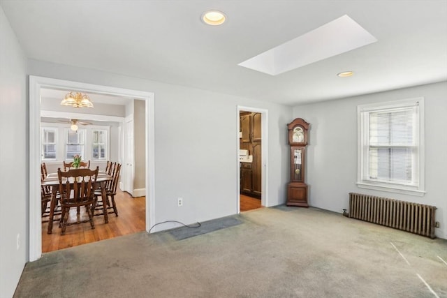 45 Franklin Ave, Quincy, MA 02170 - carpeted living room featuring a skylight, recessed lighting, a ceiling fan, and radiator heating unit
