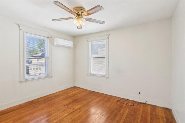 45 Franklin Ave, Quincy, MA 02170 - unfurnished room featuring a ceiling fan, baseboards, light wood-style flooring, and a wall mounted AC