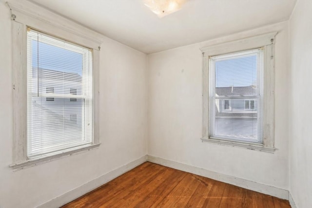 45 Franklin Ave, Quincy, MA 02170 - unfurnished room featuring wood finished floors, baseboards, and a healthy amount of sunlight