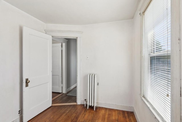45 Franklin Ave, Quincy, MA 02170 - empty room featuring radiator, plenty of natural light, dark wood-style flooring, and baseboards