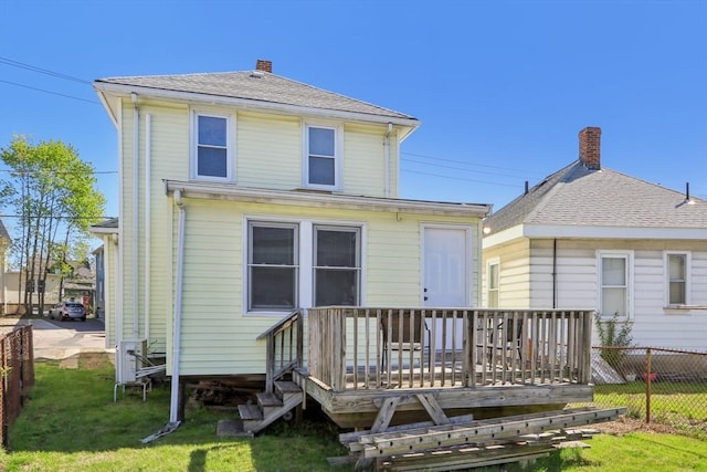 45 Franklin Ave, Quincy, MA 02170 - rear view of house featuring a chimney, a deck, fence, and a lawn