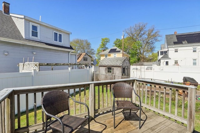 45 Franklin Ave, Quincy, MA 02170 - wooden terrace featuring an outbuilding, a fenced backyard, and a storage unit
