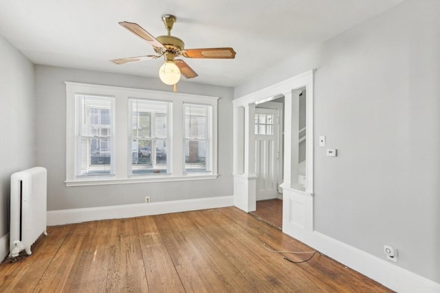 45 Franklin Ave, Quincy, MA 02170 - unfurnished room with baseboards, radiator heating unit, a ceiling fan, and wood finished floors