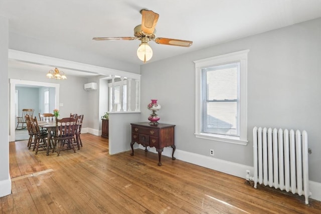 45 Franklin Ave, Quincy, MA 02170 - dining space with ceiling fan with notable chandelier, radiator, baseboards, an AC wall unit, and hardwood / wood-style flooring