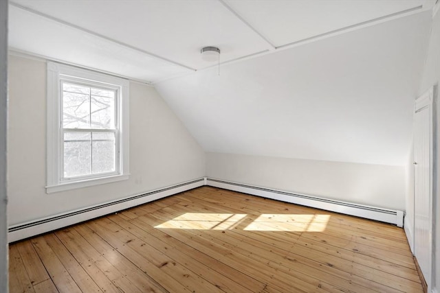 bonus room featuring baseboard heating, vaulted ceiling, and light wood-type flooring