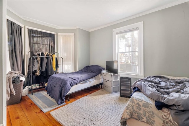 bedroom featuring ornamental molding and hardwood / wood-style floors