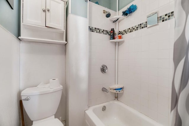 bathroom featuring shower / bathtub combination with curtain and toilet