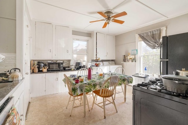 kitchen featuring black appliances, separate washer and dryer, ceiling fan, decorative backsplash, and white cabinets