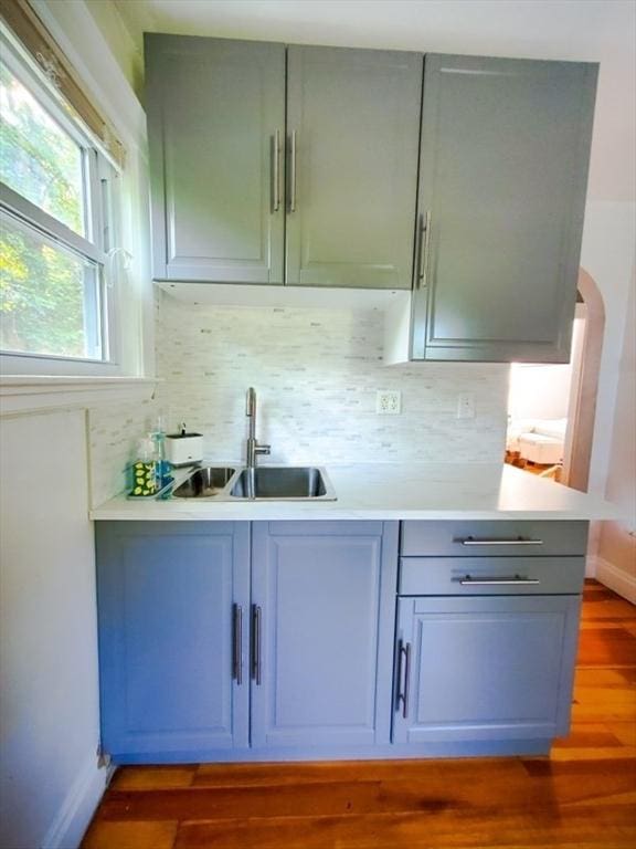 kitchen with backsplash, dark hardwood / wood-style floors, and sink