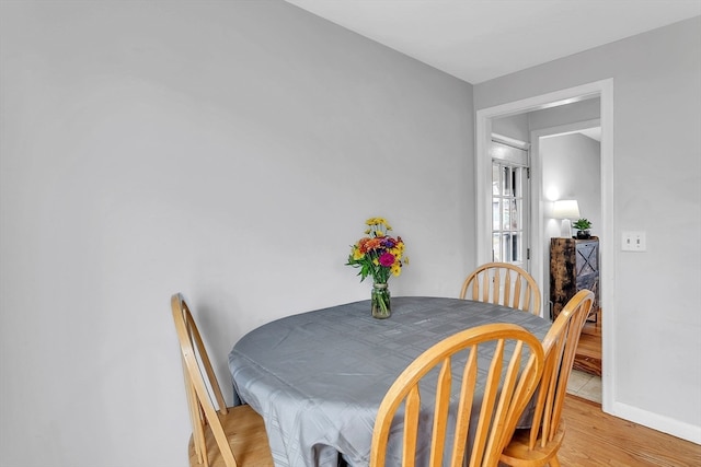 dining area with light hardwood / wood-style floors