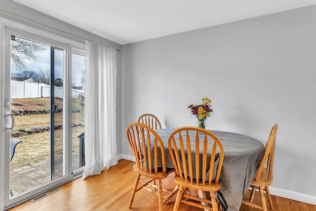 dining area with light wood-type flooring