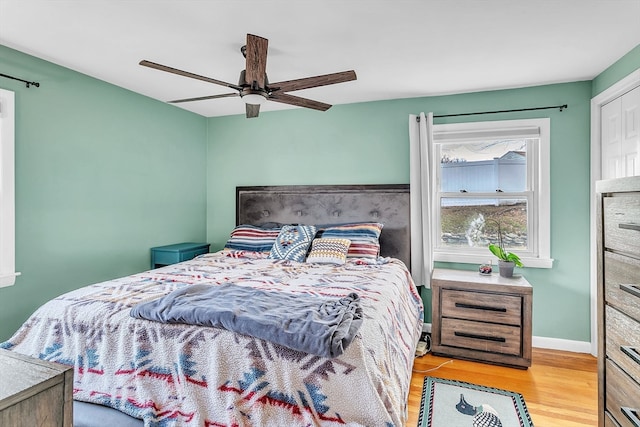 bedroom with light hardwood / wood-style floors and ceiling fan