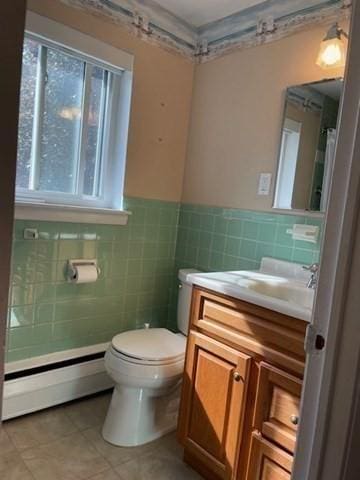 50 Wilson Dr Unit 50, Framingham, MA 01702 - bathroom featuring a baseboard radiator, tile walls, vanity, toilet, and tile patterned flooring