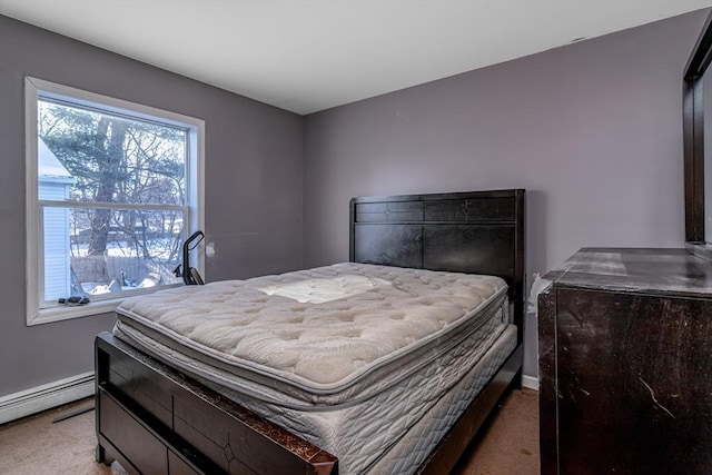 bedroom with a baseboard radiator, baseboards, and carpet flooring