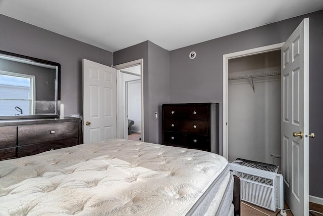 bedroom featuring a closet and an AC wall unit