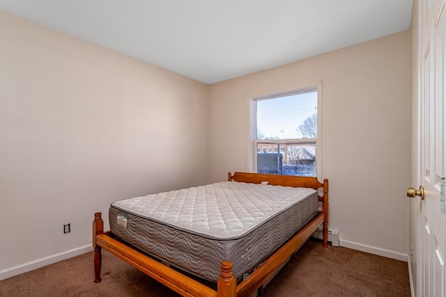 bedroom featuring dark carpet, a baseboard radiator, and baseboards