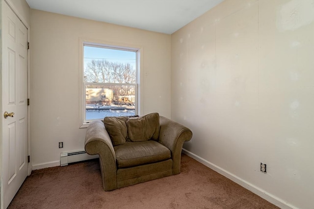 living area featuring a baseboard heating unit, carpet flooring, and baseboards