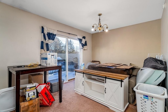 carpeted bedroom with access to exterior and a notable chandelier