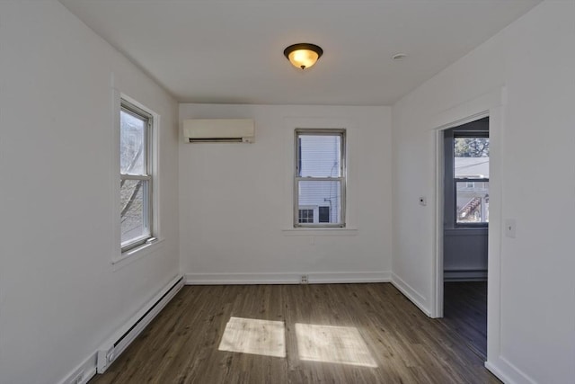 empty room with a baseboard heating unit, baseboards, a wall mounted air conditioner, baseboard heating, and wood finished floors