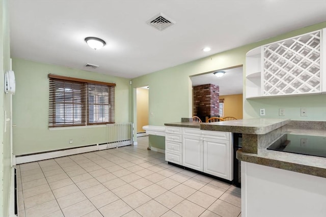 kitchen featuring kitchen peninsula, black electric cooktop, light tile patterned floors, a baseboard radiator, and white cabinetry