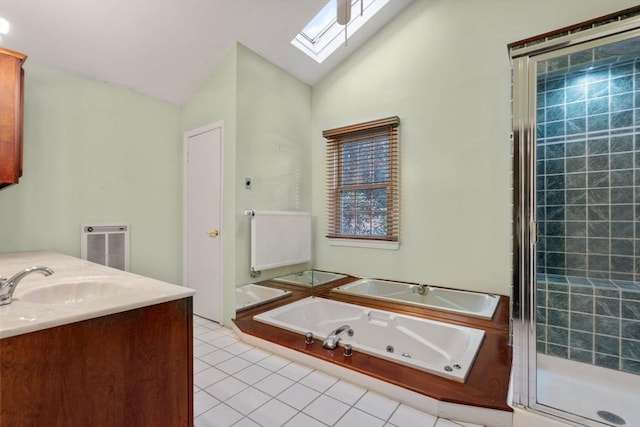 bathroom with vanity, lofted ceiling with skylight, tile patterned flooring, separate shower and tub, and radiator heating unit