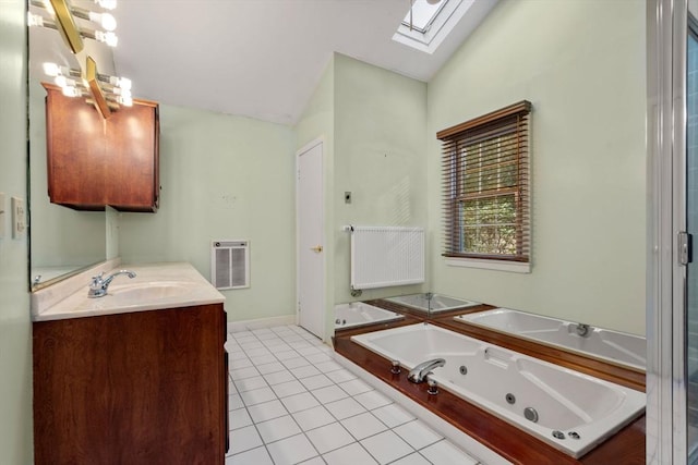 bathroom with radiator heating unit, tile patterned floors, heating unit, lofted ceiling with skylight, and vanity