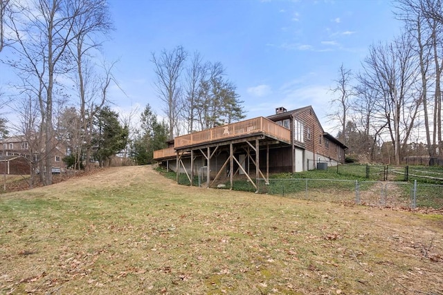 rear view of house with a yard and a wooden deck