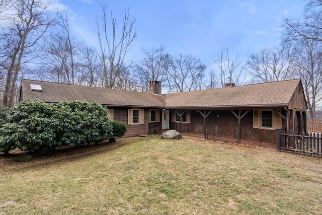 back of house featuring a yard