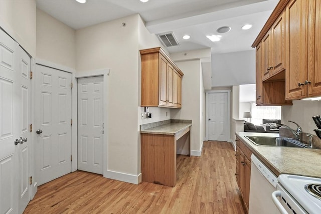 kitchen featuring white appliances, baseboards, light wood-style flooring, light countertops, and a sink