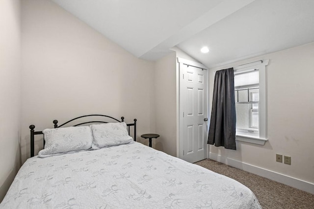 bedroom with lofted ceiling, baseboards, and carpet flooring