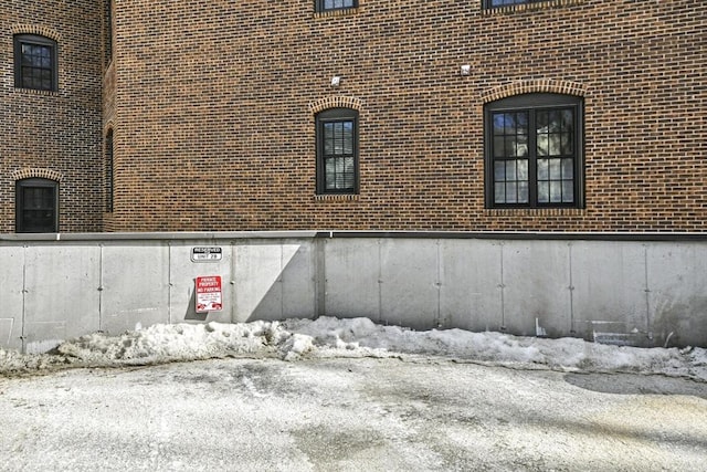 view of side of property featuring brick siding